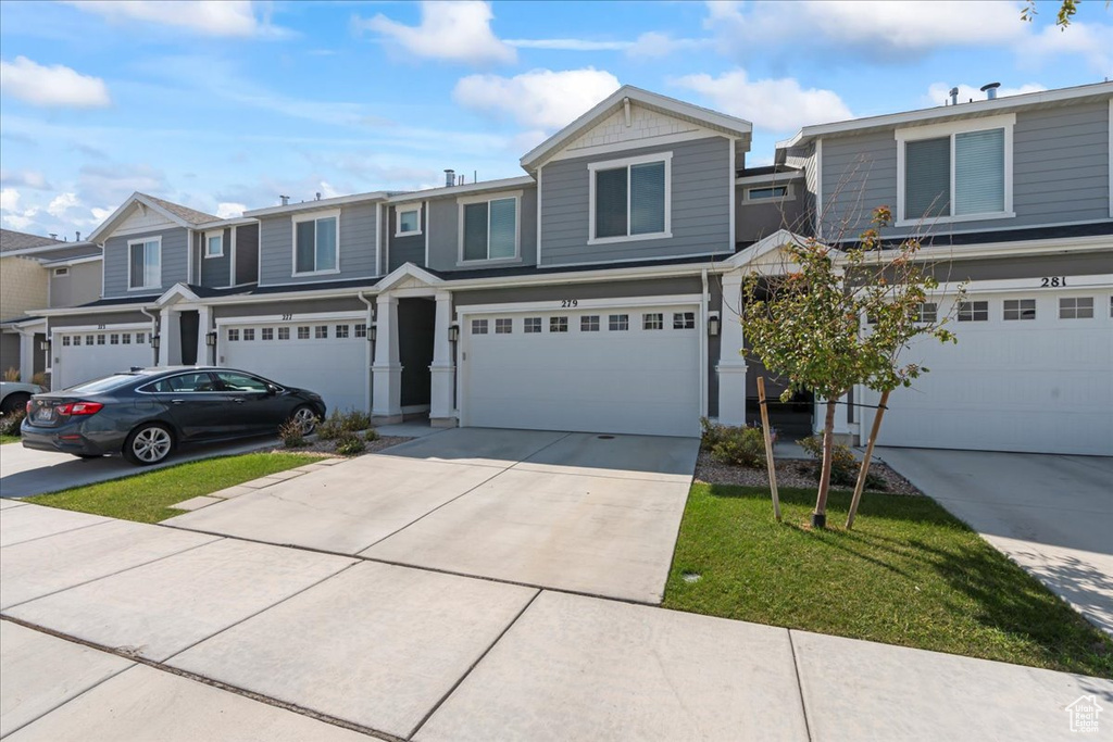 View of front facade featuring a garage