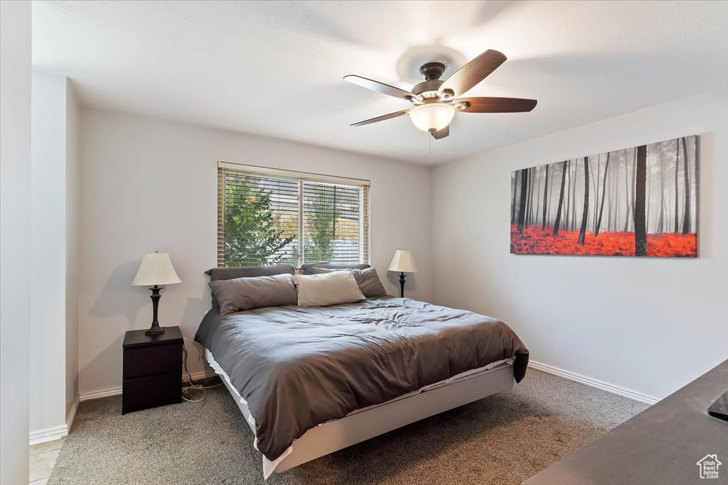 Carpeted bedroom with ceiling fan