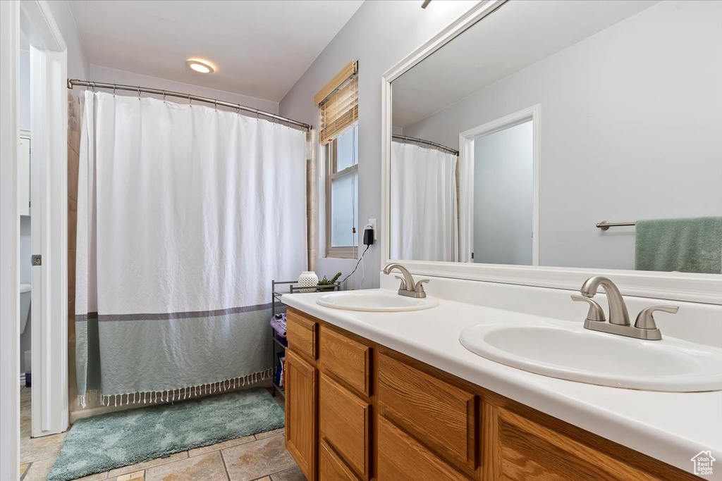 Bathroom with tile patterned flooring and vanity