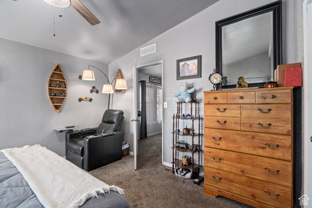 Carpeted bedroom with lofted ceiling and ceiling fan