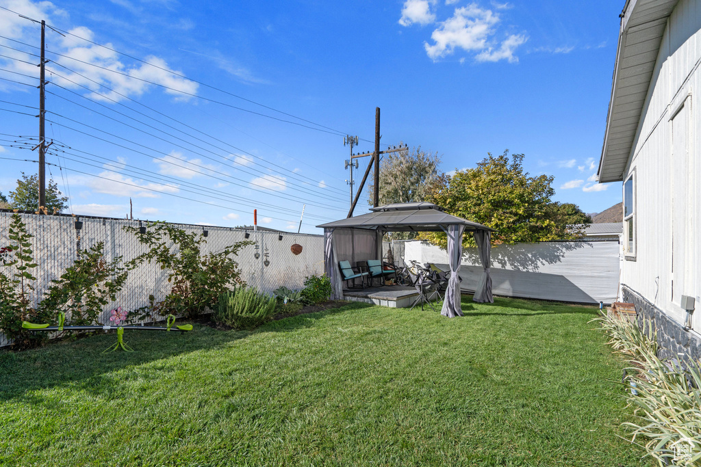 View of yard with a gazebo and a patio area