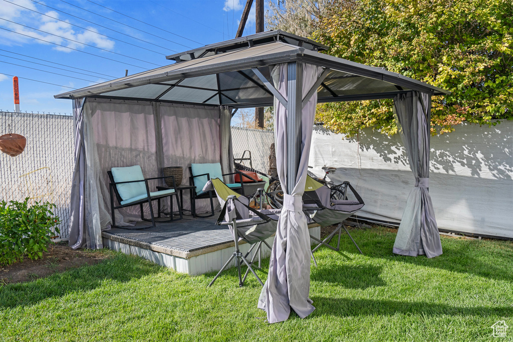 Exterior space featuring a gazebo, a yard, and a water view