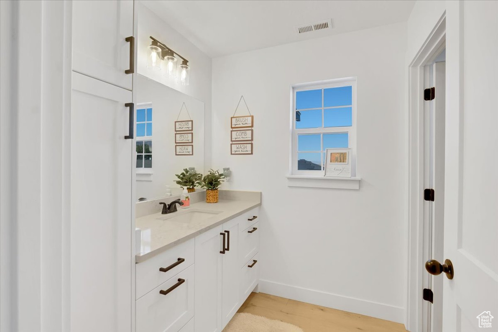 Bathroom with hardwood / wood-style floors and vanity