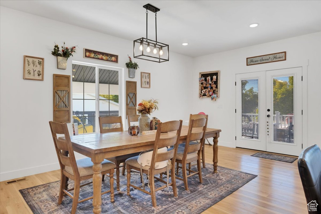 Dining room with french doors and light hardwood / wood-style floors