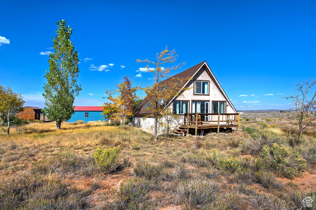 Rear view of house featuring a deck