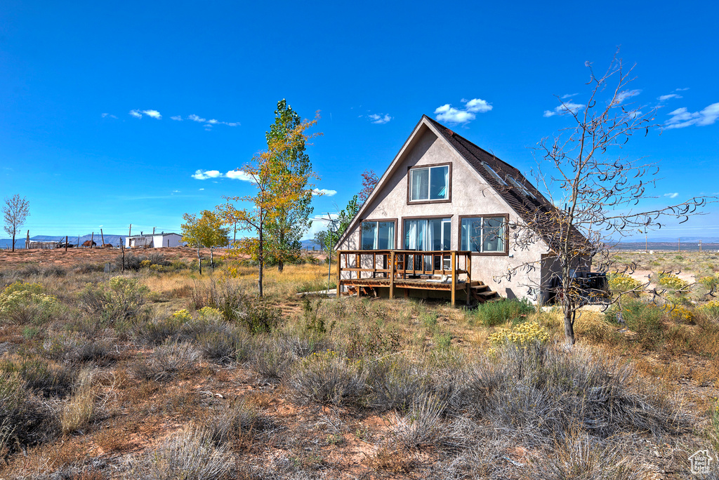 Back of house with a deck