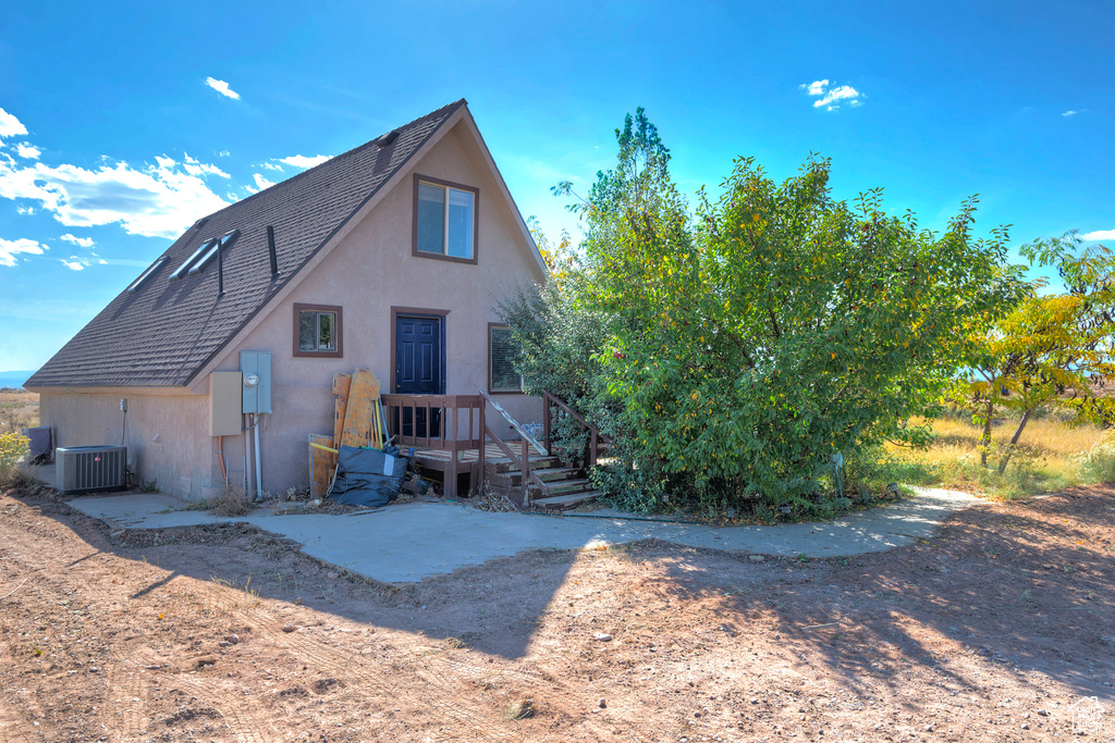 Back of house featuring central AC unit