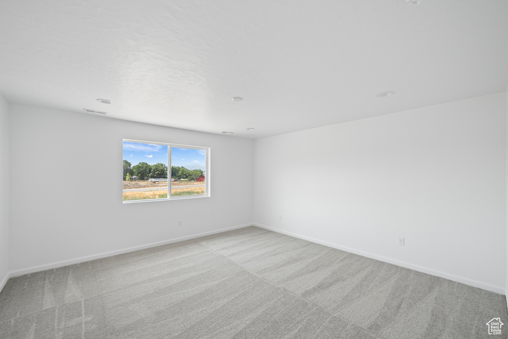 Spare room with light colored carpet