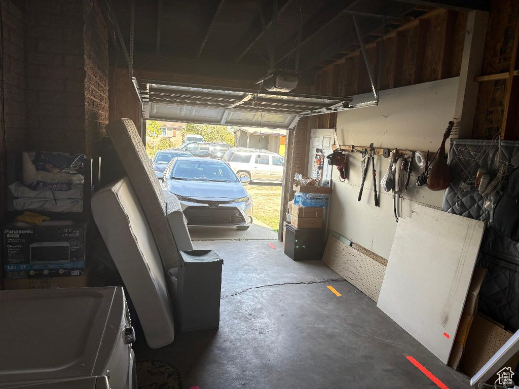 Garage with a garage door opener and washer / clothes dryer