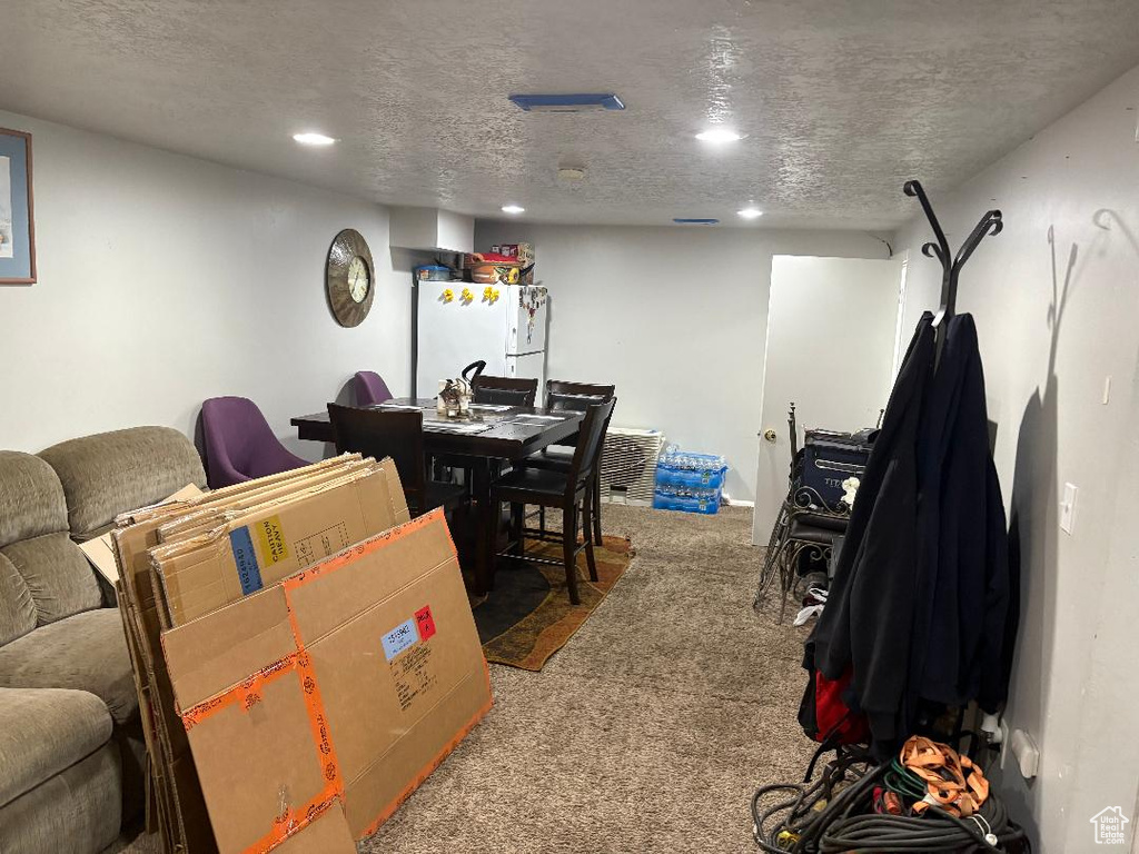 Interior space featuring a textured ceiling and carpet flooring