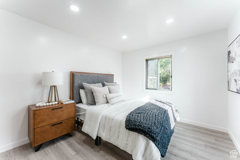 Bedroom with light hardwood / wood-style floors