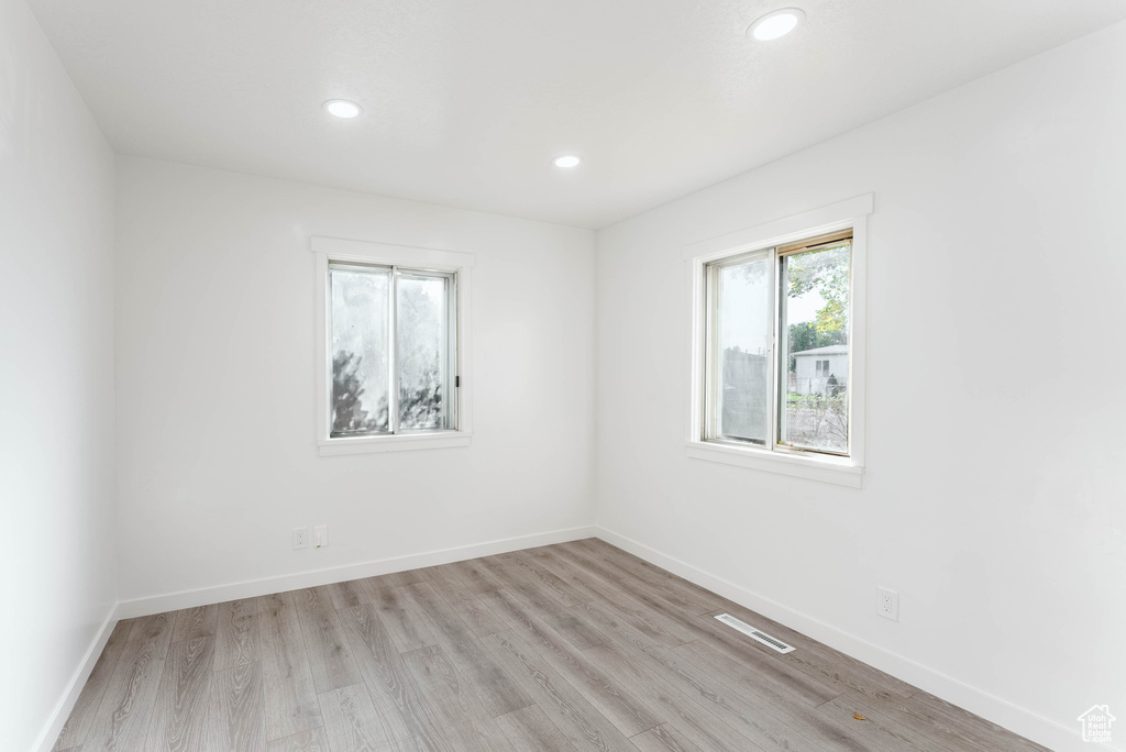 Unfurnished room with light hardwood / wood-style flooring