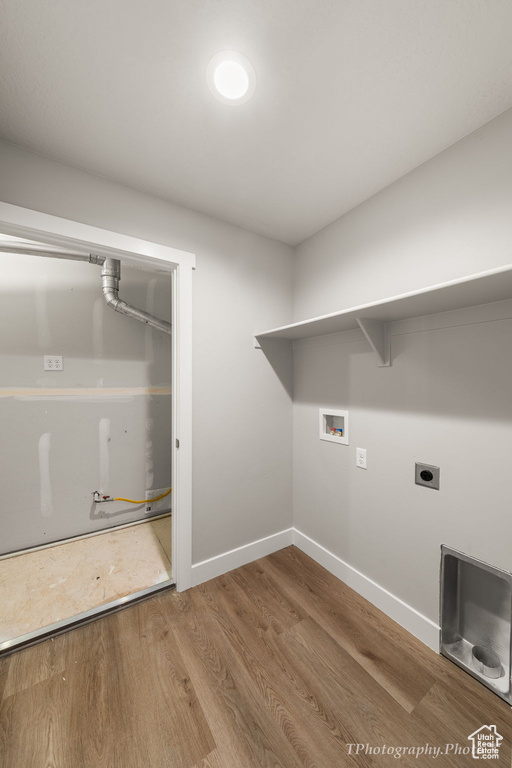 Laundry room featuring hookup for a washing machine, hardwood / wood-style floors, and electric dryer hookup