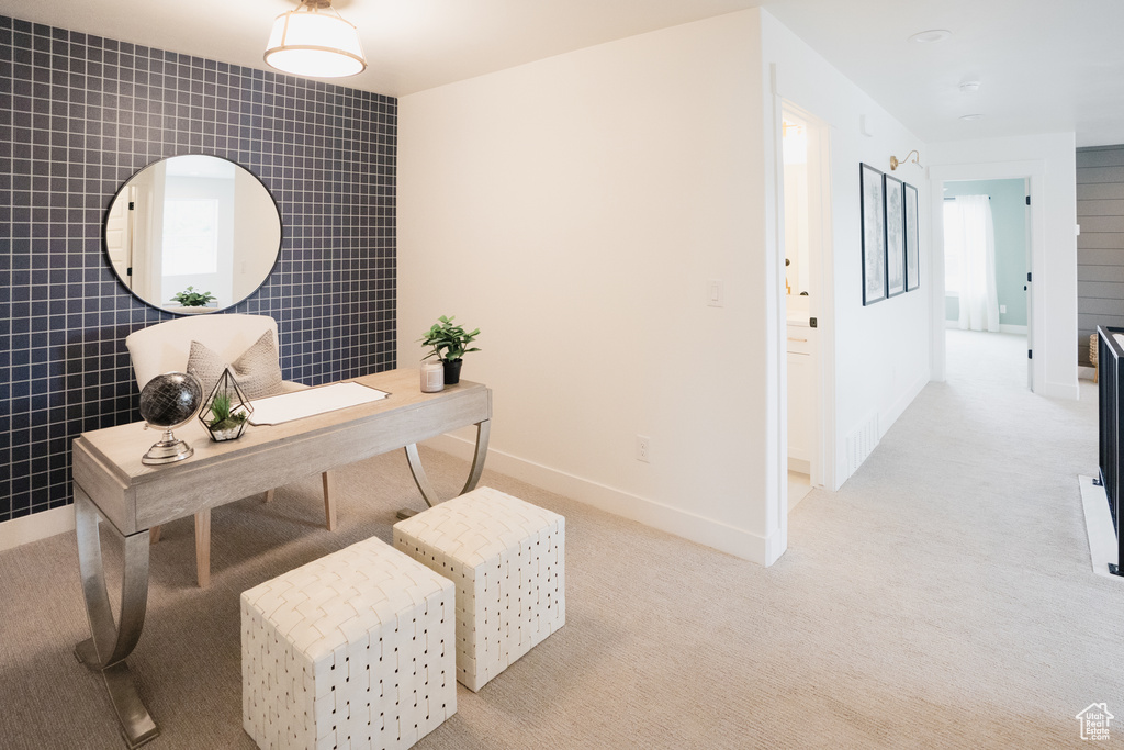 Carpeted office space featuring tile walls