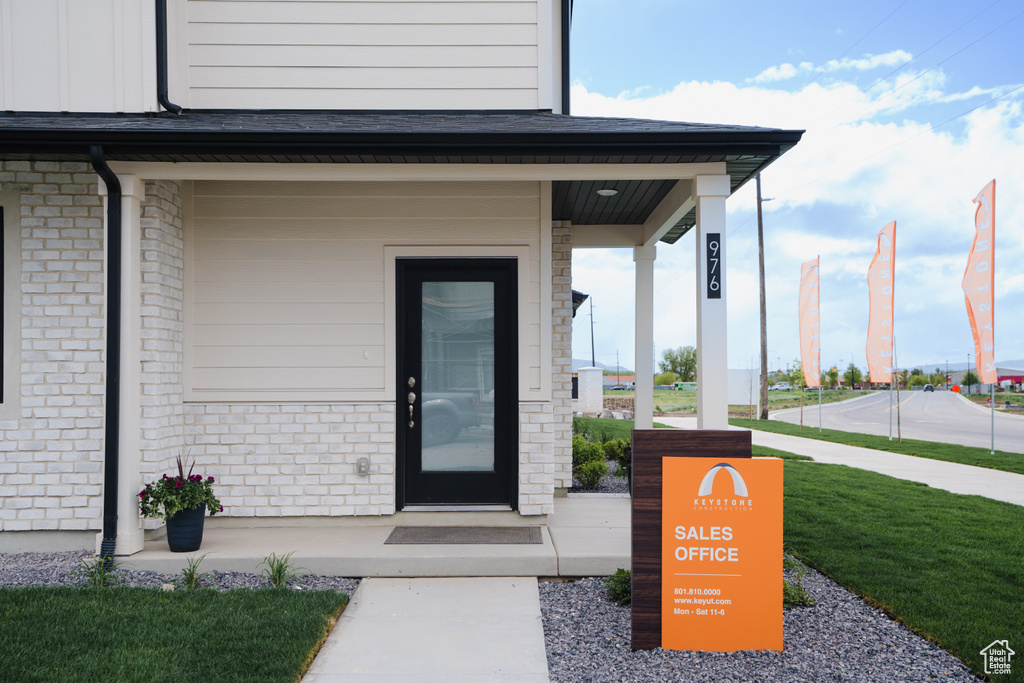 Doorway to property with a lawn