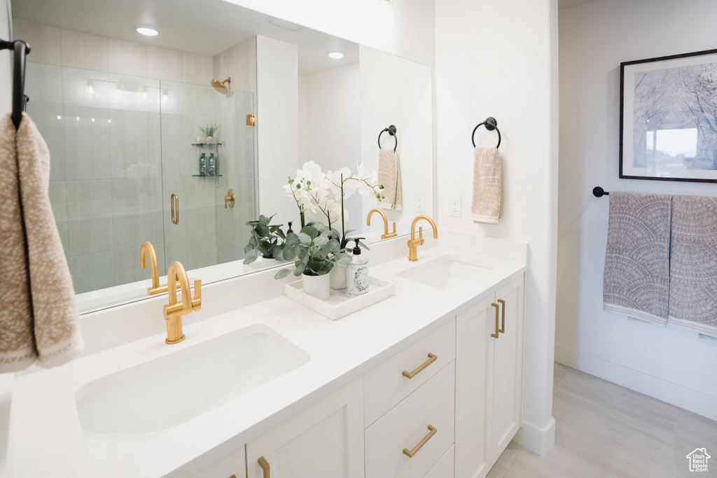 Bathroom featuring walk in shower, hardwood / wood-style flooring, and vanity