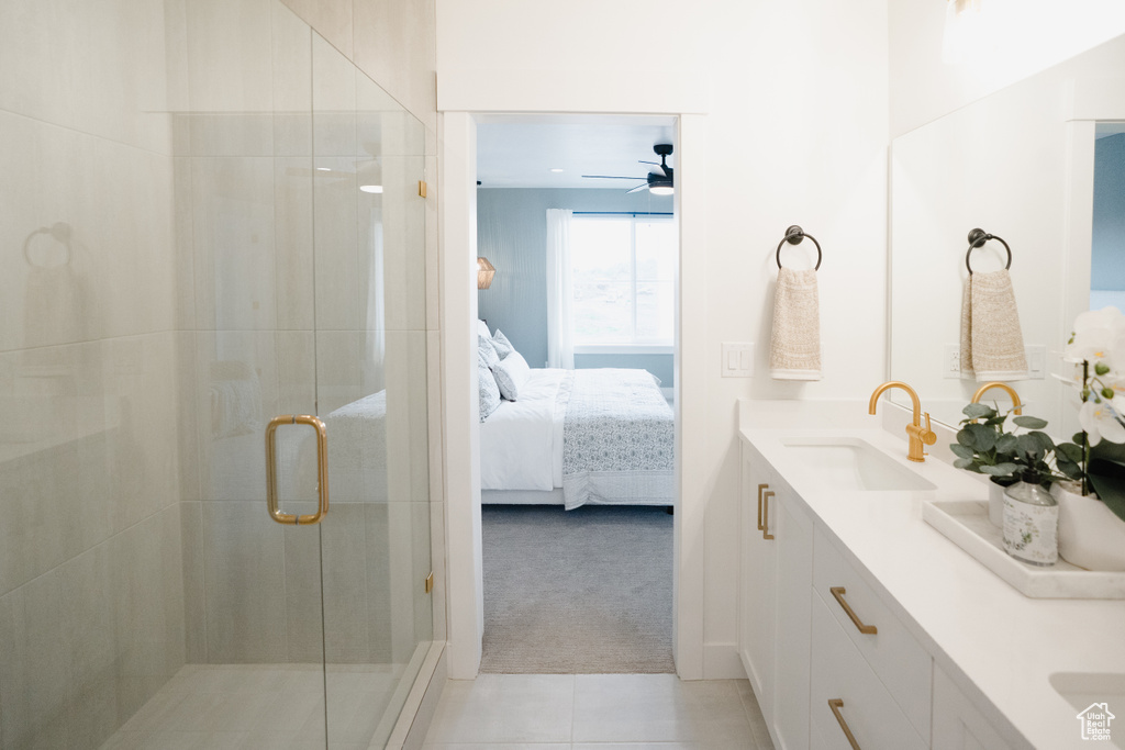 Bathroom featuring an enclosed shower, tile patterned floors, vanity, and ceiling fan