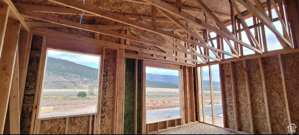 Miscellaneous room featuring a wealth of natural light, lofted ceiling, and a mountain view