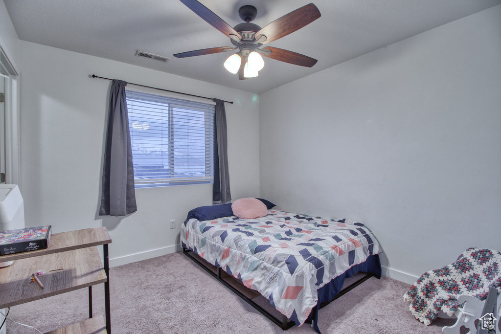 Carpeted bedroom with ceiling fan