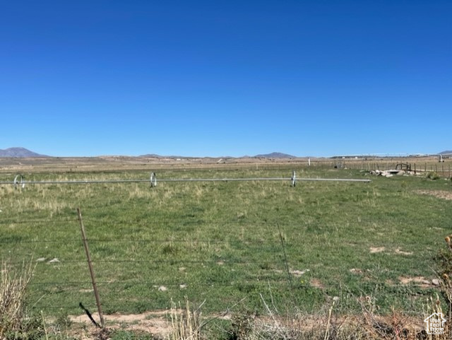 View of yard featuring a rural view and a mountain view