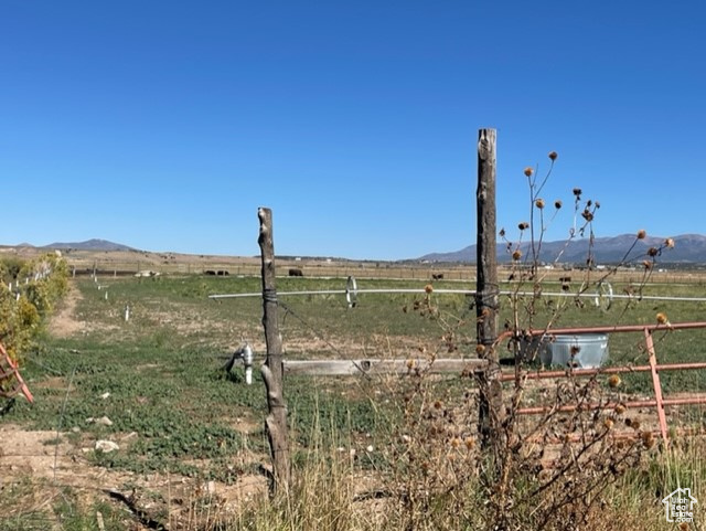 View of yard featuring a rural view and a mountain view