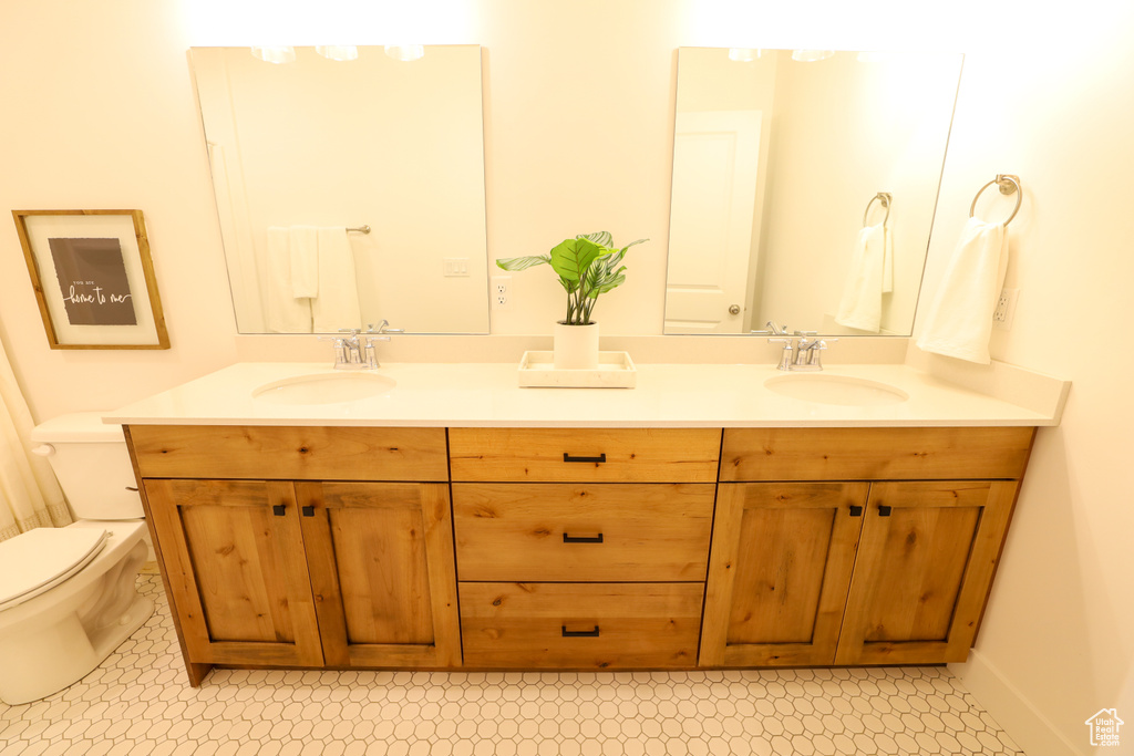 Bathroom with vanity, tile patterned flooring, and toilet