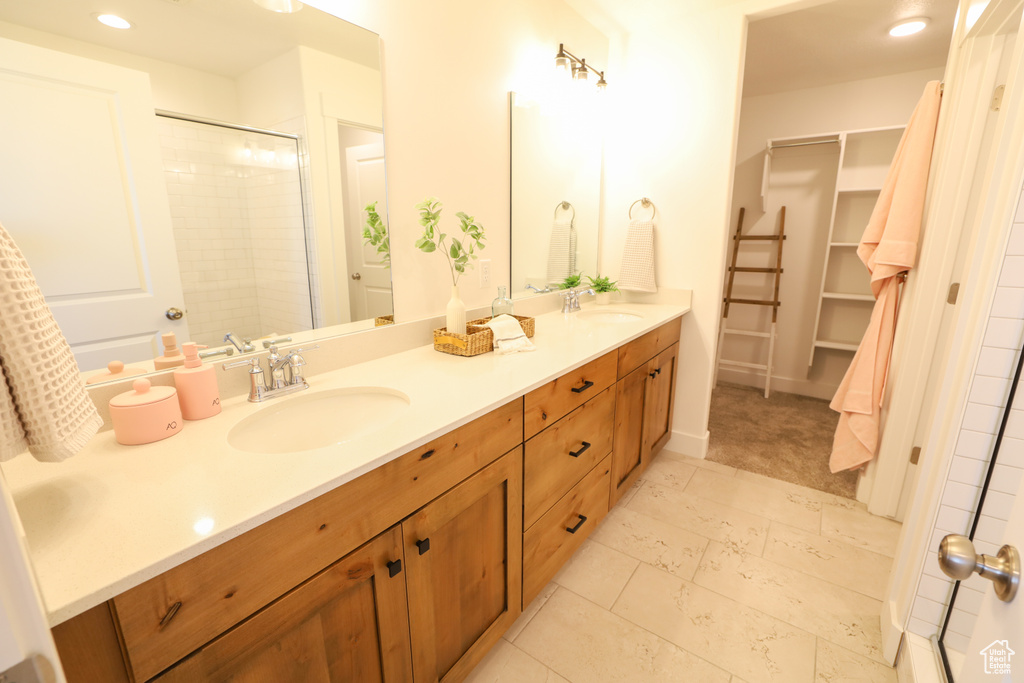 Bathroom featuring an enclosed shower and vanity