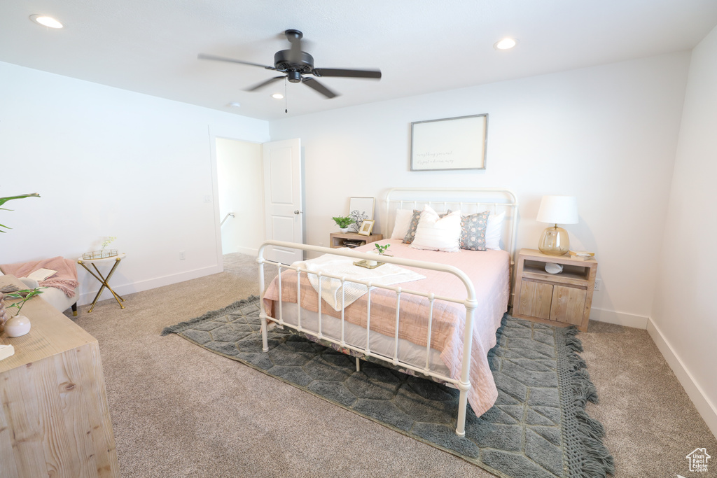 Carpeted bedroom with ceiling fan