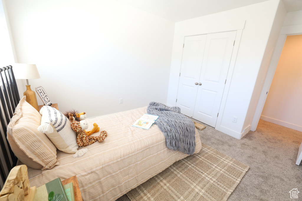 Bedroom featuring a closet and carpet flooring