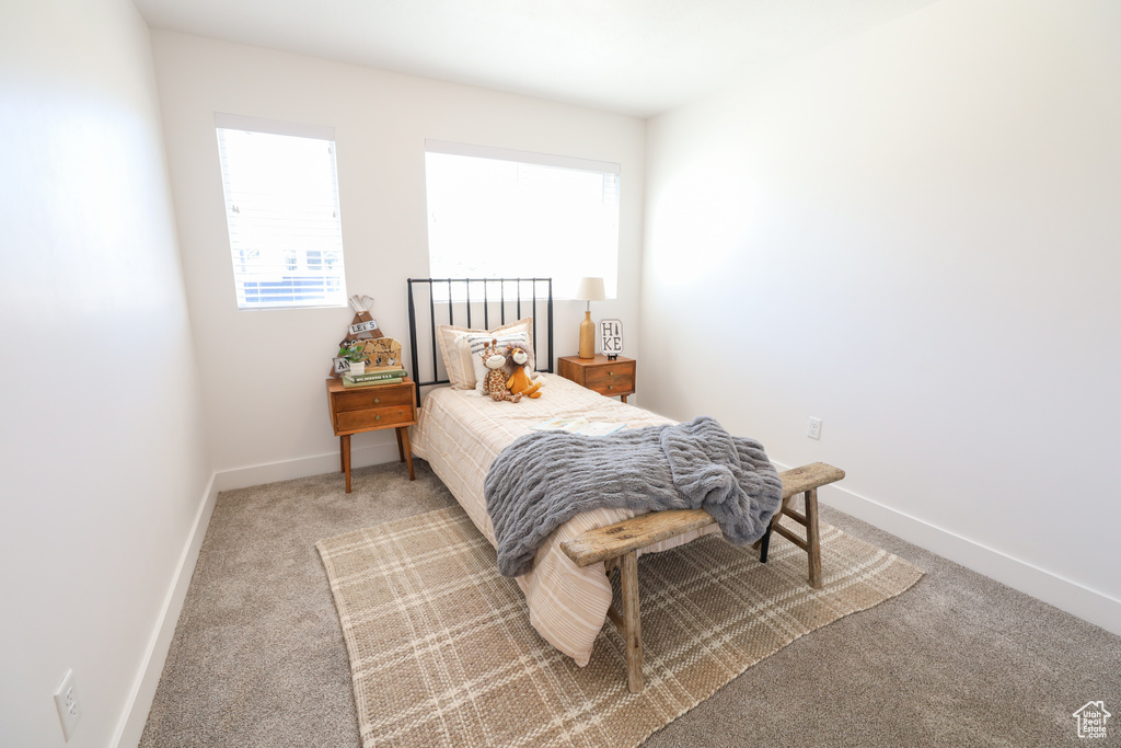 Bedroom featuring carpet floors and multiple windows