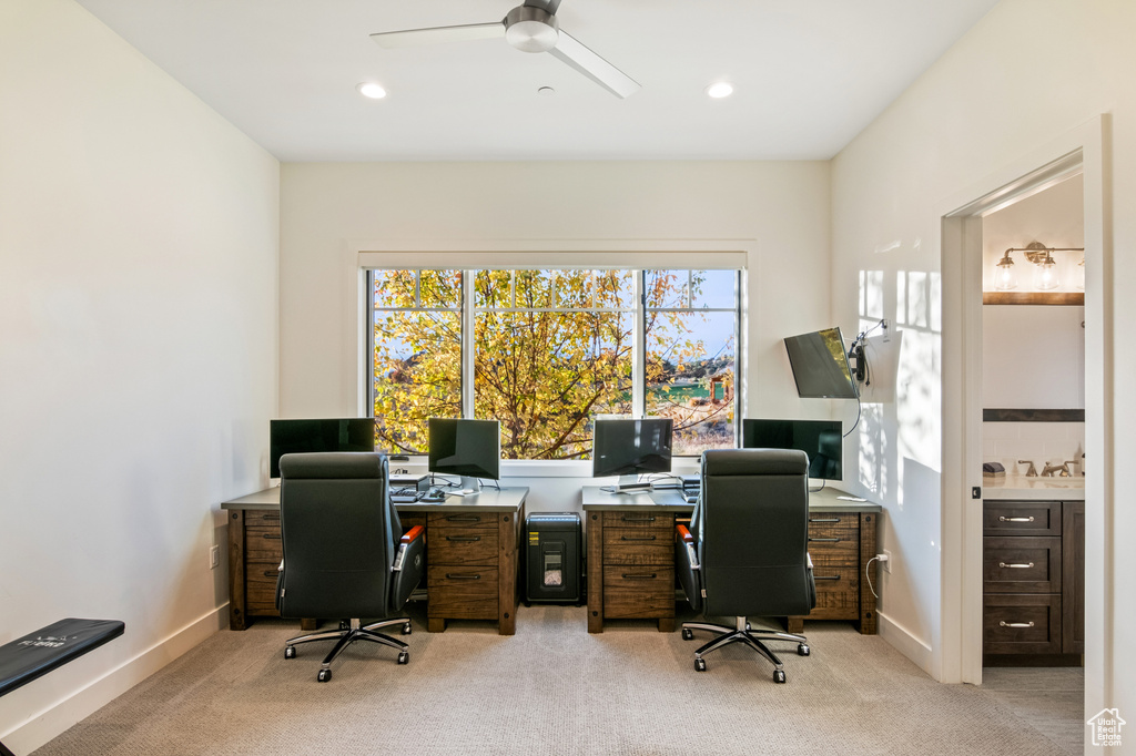 Office space featuring light carpet and ceiling fan