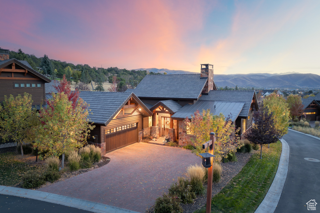 View of front of home featuring a garage and a mountain view