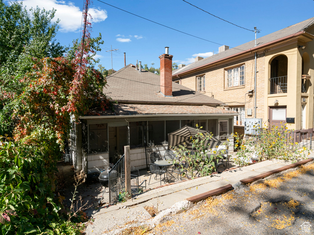 Rear view of property featuring a sunroom