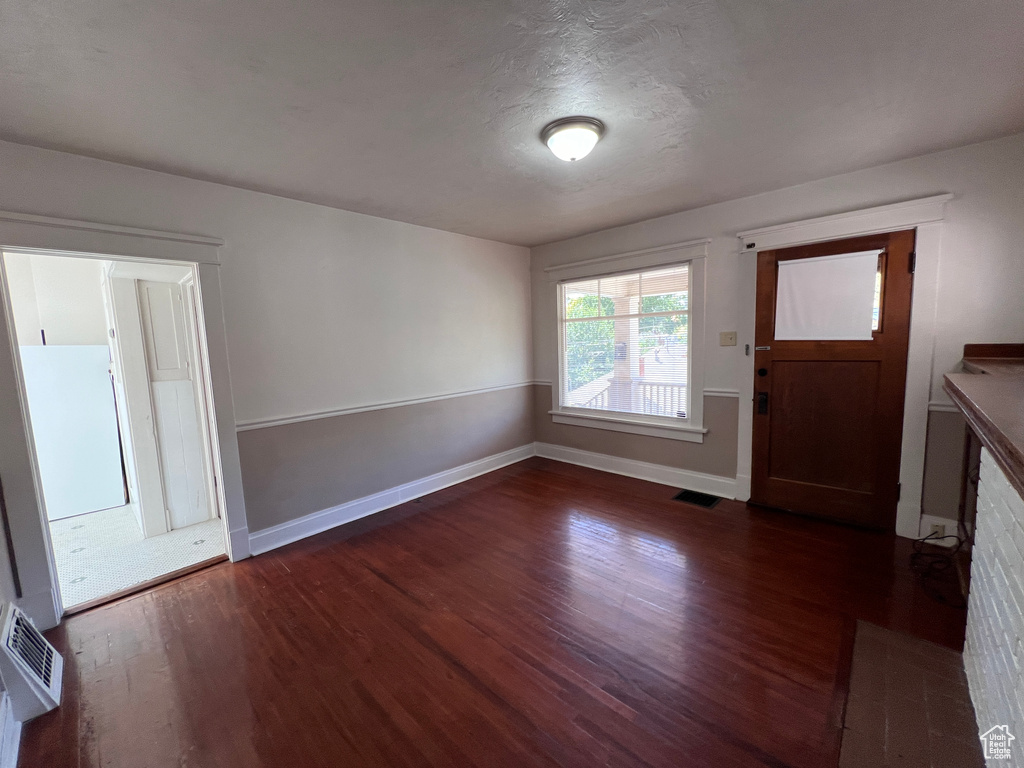 Foyer entrance with dark hardwood / wood-style flooring