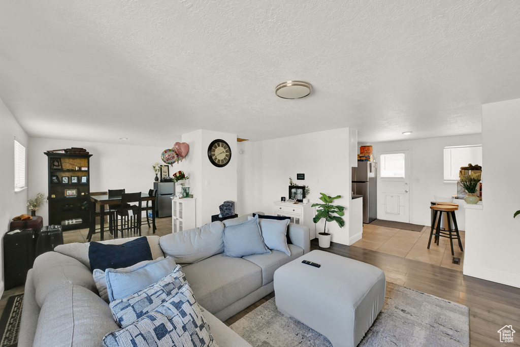 Living room featuring a textured ceiling and light hardwood / wood-style flooring