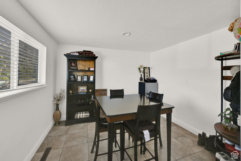 Dining area featuring light tile patterned floors