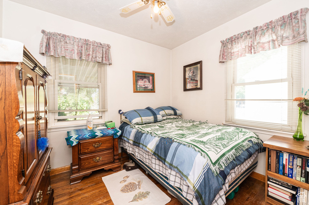 Bedroom with ceiling fan and dark hardwood / wood-style flooring