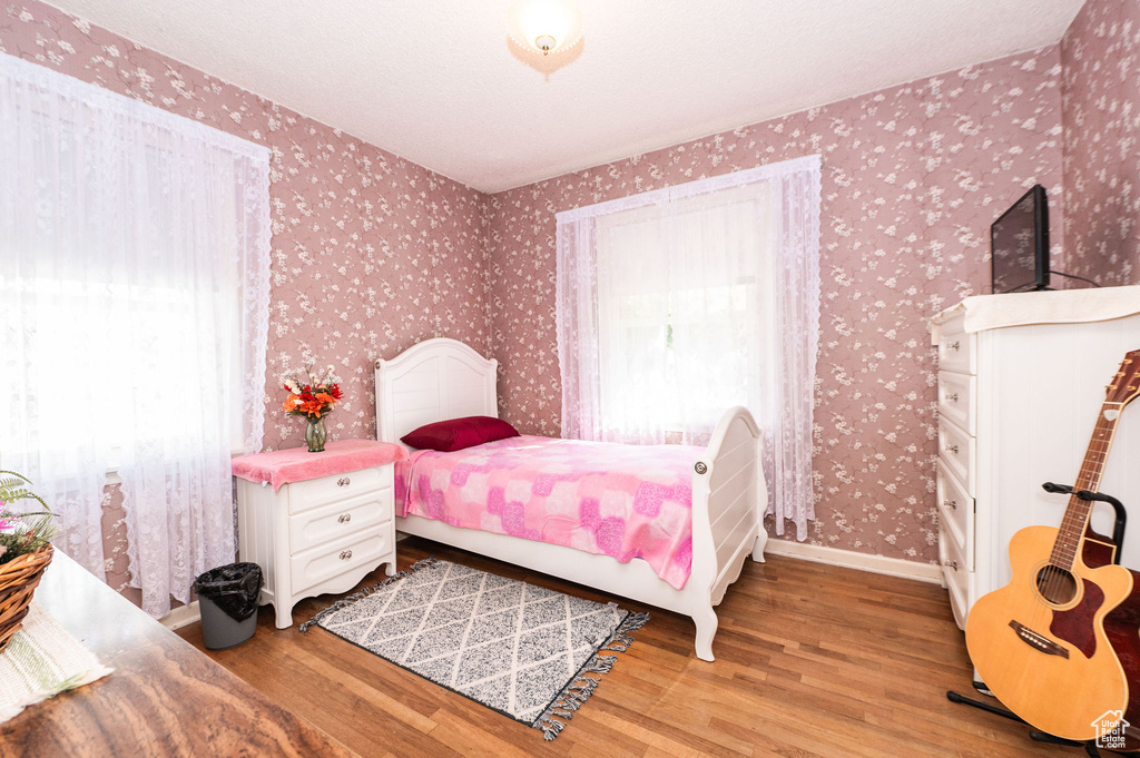 Bedroom with hardwood / wood-style flooring