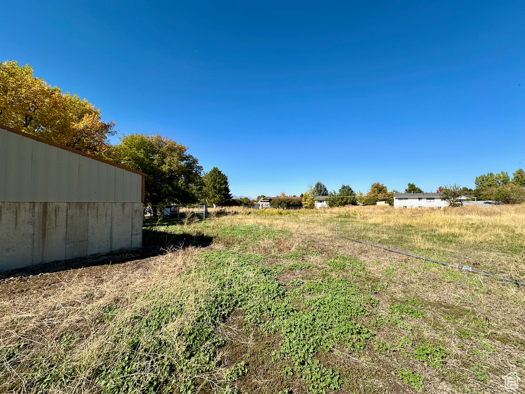 View of yard with a rural view