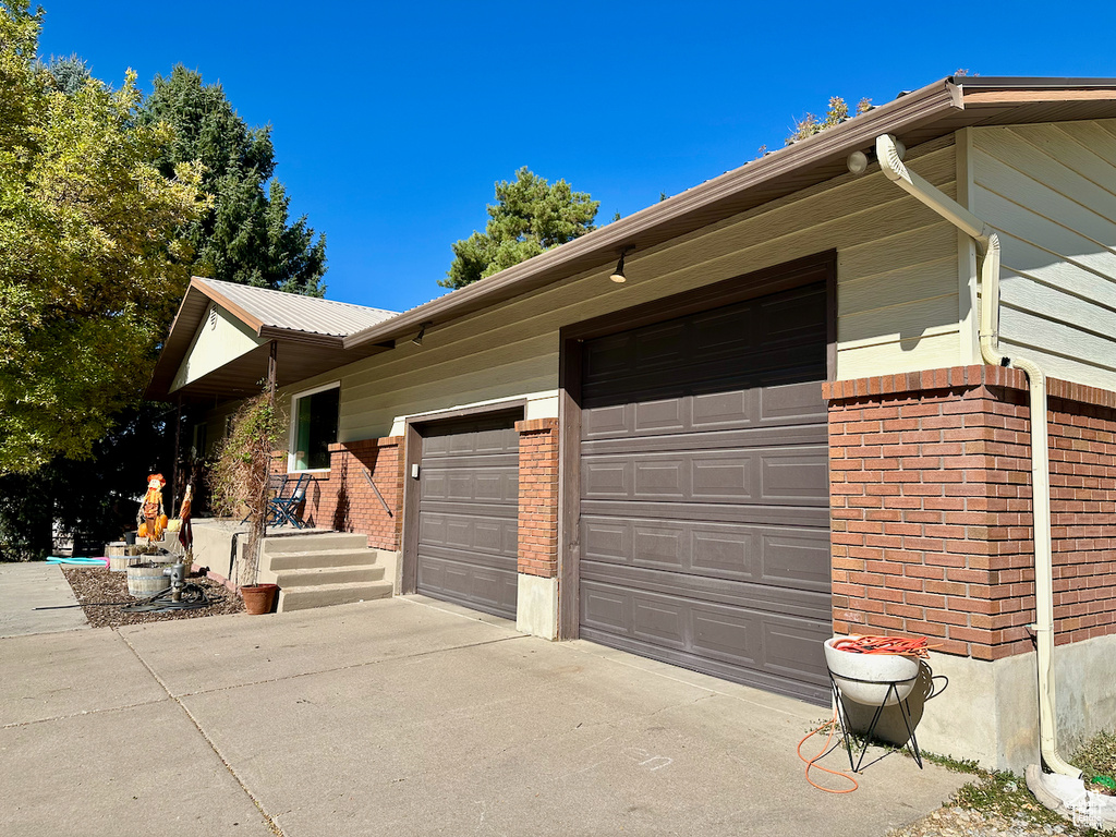 View of side of home with a garage