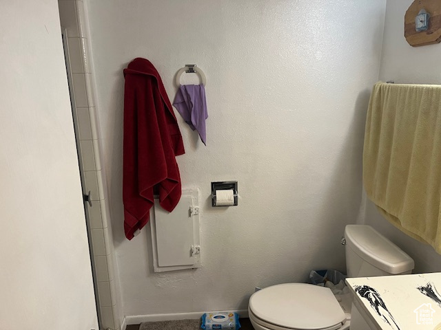 Bathroom with a shower with shower door and toilet