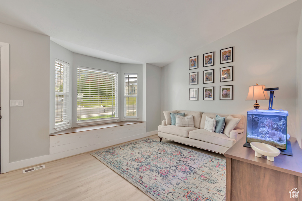 Living room featuring lofted ceiling and hardwood / wood-style floors