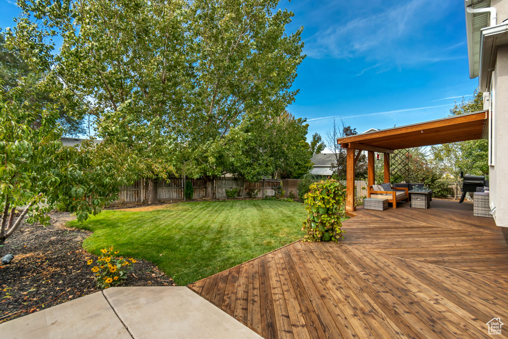 View of yard featuring an outdoor living space and a deck