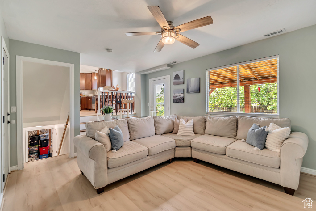 Living room featuring ceiling fan and light hardwood / wood-style floors