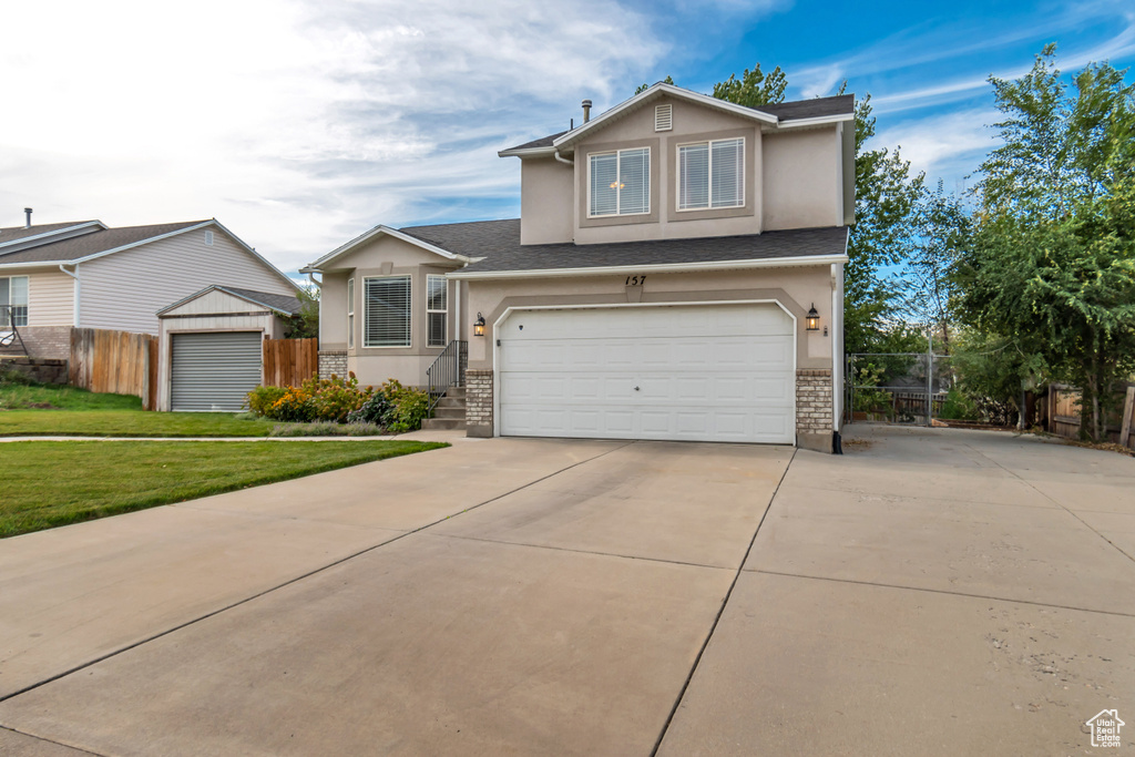 View of front facade with a front yard and a garage