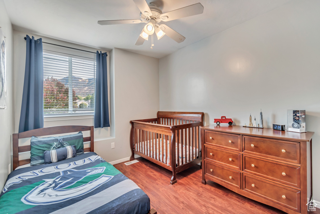 Bedroom with ceiling fan and wood-type flooring