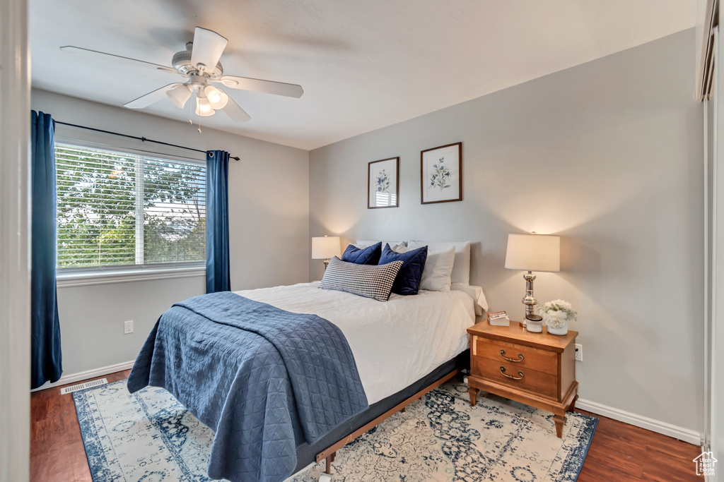 Bedroom featuring dark hardwood / wood-style flooring and ceiling fan