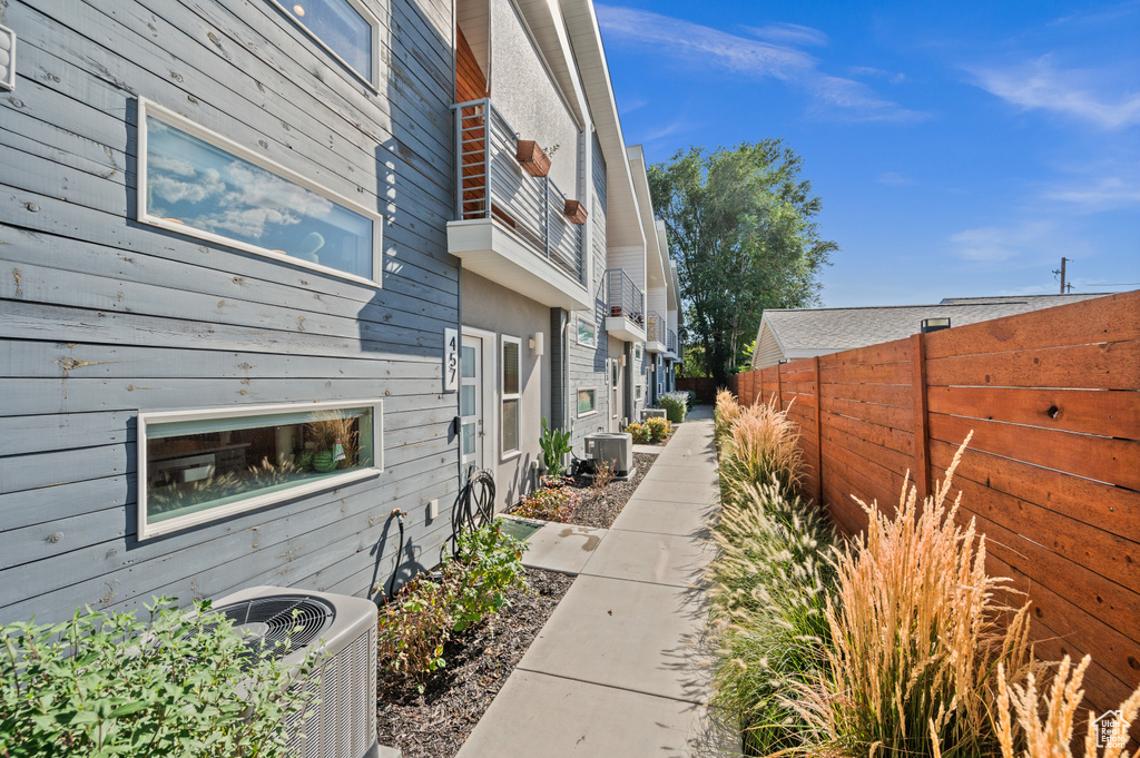 View of side of home with central AC