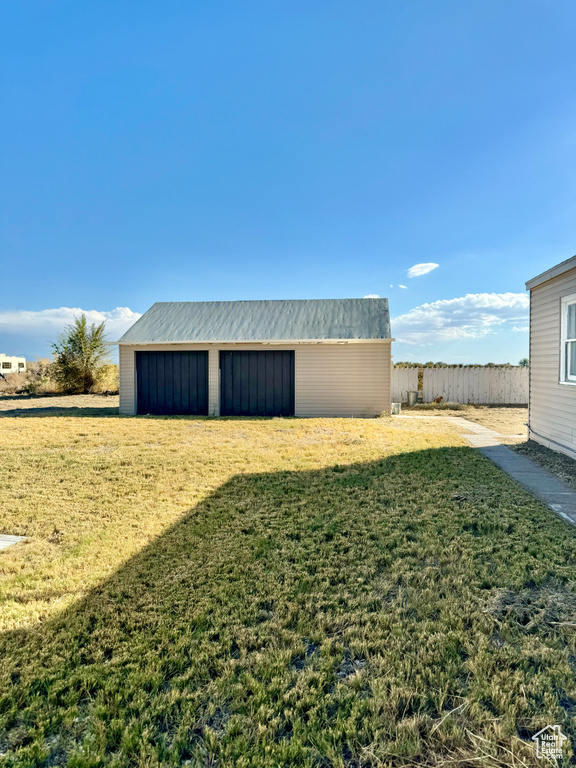 Exterior space featuring a garage and an outbuilding