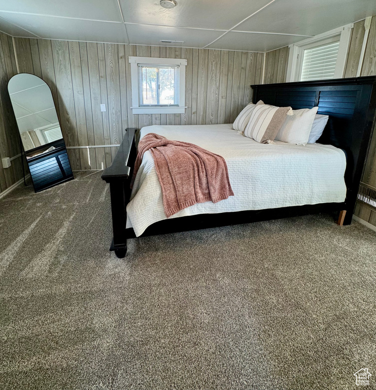 Carpeted bedroom with wooden walls